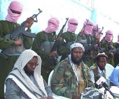 Fuad Mohamed Khalaf (in the middle in camouflage jacket)